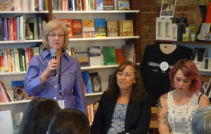 Mary Raynovich (left) of the Salvation Army's Wellspring Program, talks to the crowd about working with trafficking survivors.
